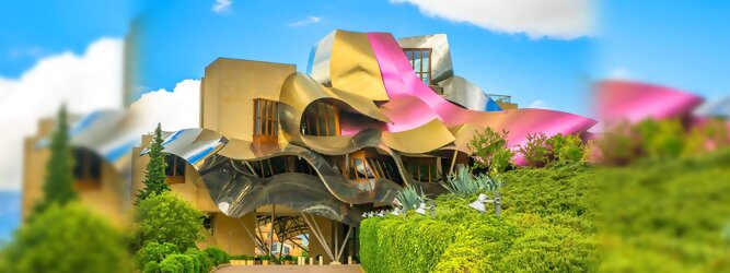 Trip Albanien Reisetipps - Marqués de Riscal Design Hotel, Bilbao, Elciego, Spanien. Fantastisch galaktisch, unverkennbar ein Werk von Frank O. Gehry. Inmitten idyllischer Weinberge in der Rioja Region des Baskenlandes, bezaubert das schimmernde Bauobjekt mit einer Struktur bunter, edel glänzender verflochtener Metallbänder. Glanz im Baskenland - Es muss etwas ganz Besonderes sein. Emotional, zukunftsweisend, einzigartig. Denn in dieser Region, etwa 133 km südlich von Bilbao, sind Weingüter normalerweise nicht für die Öffentlichkeit zugänglich.